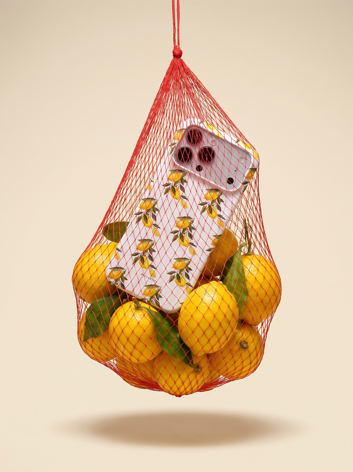 Limone phone case in a red net bag full of lemons